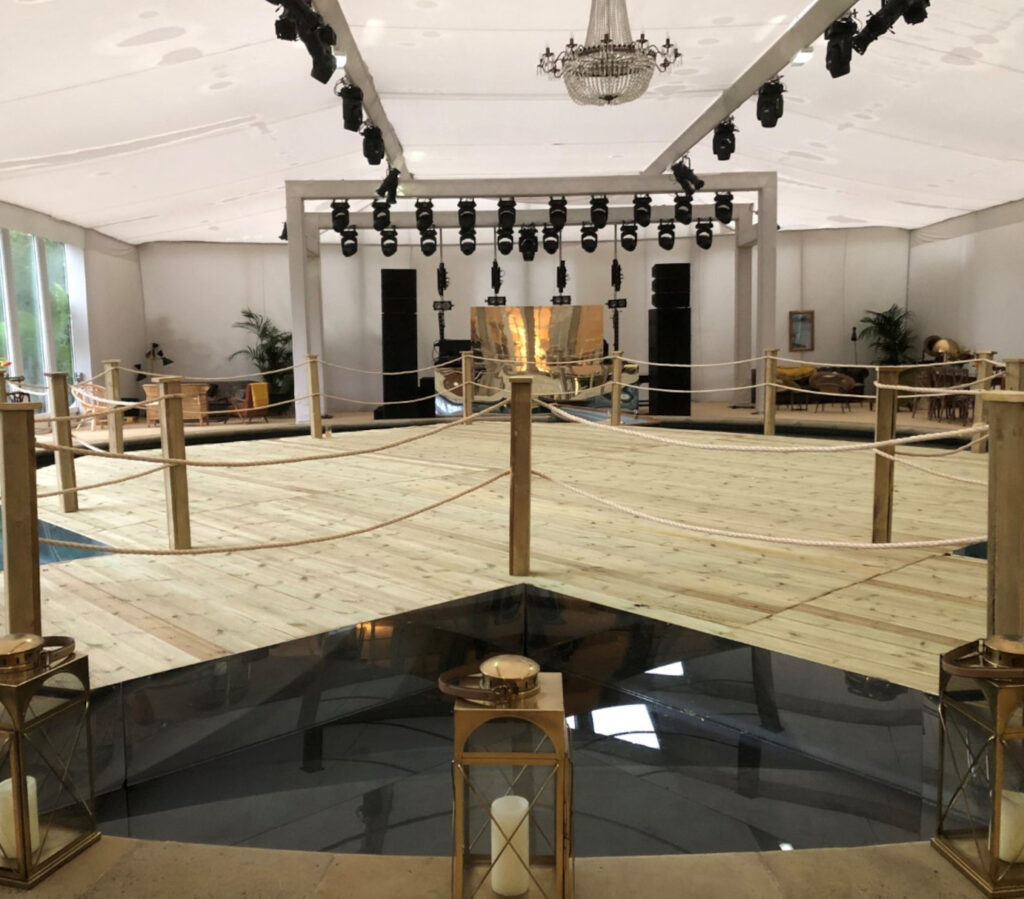 Temporary floating pontoon floor and event platform with rope balustrade and stage lighting