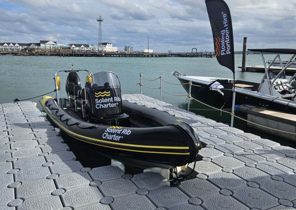 Solent Rib Charter RIB berthed within a modular floating pontoon dock, with Floating Pontoon Hire branding visible at the marina.