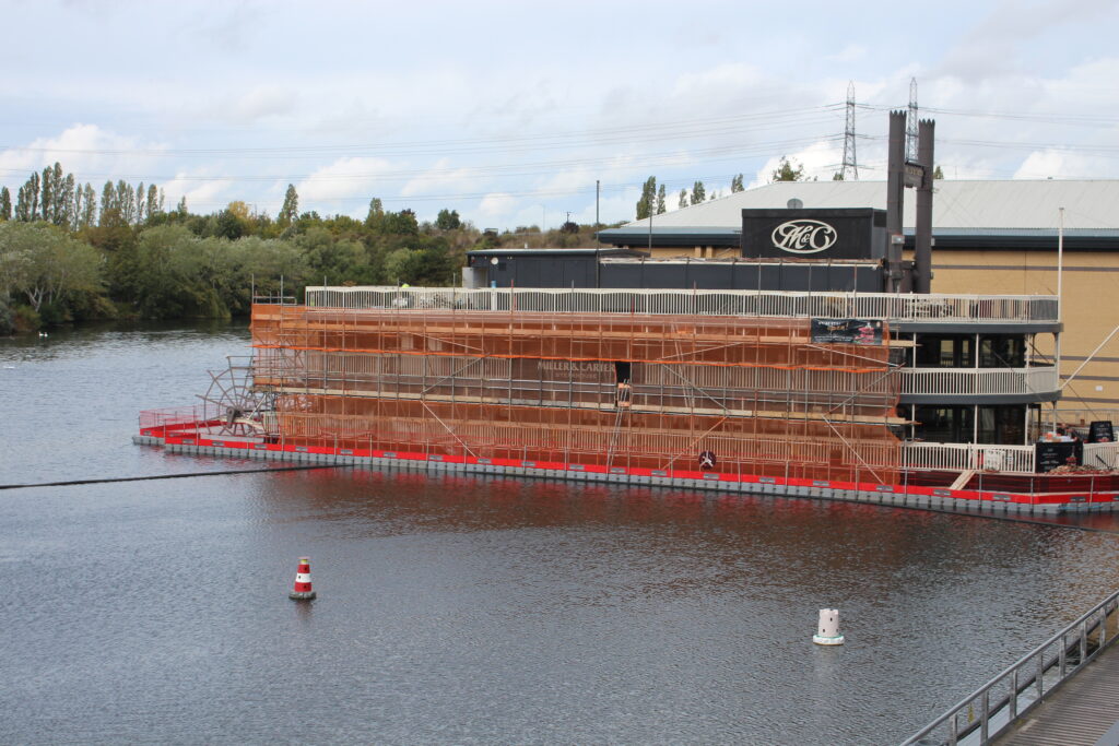 Floating pontoon hire providing a stable working platform for scaffolding and waterfront building renovation at Miller & Carter Steakhouse.